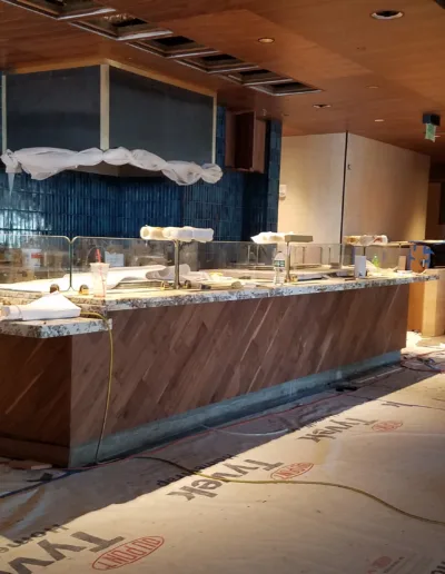 A restaurant is under construction with a large counter.
