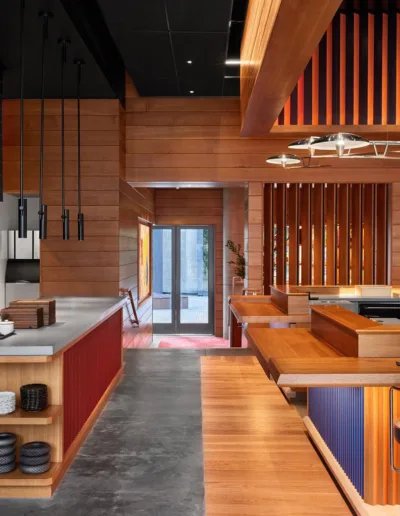 The interior of a restaurant with wooden walls and wooden floors.